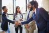Diverse colleagues shaking hands in an office